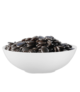 Black candy in white ceramic bowl