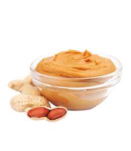 Peanut butter in glass bowl with peanut